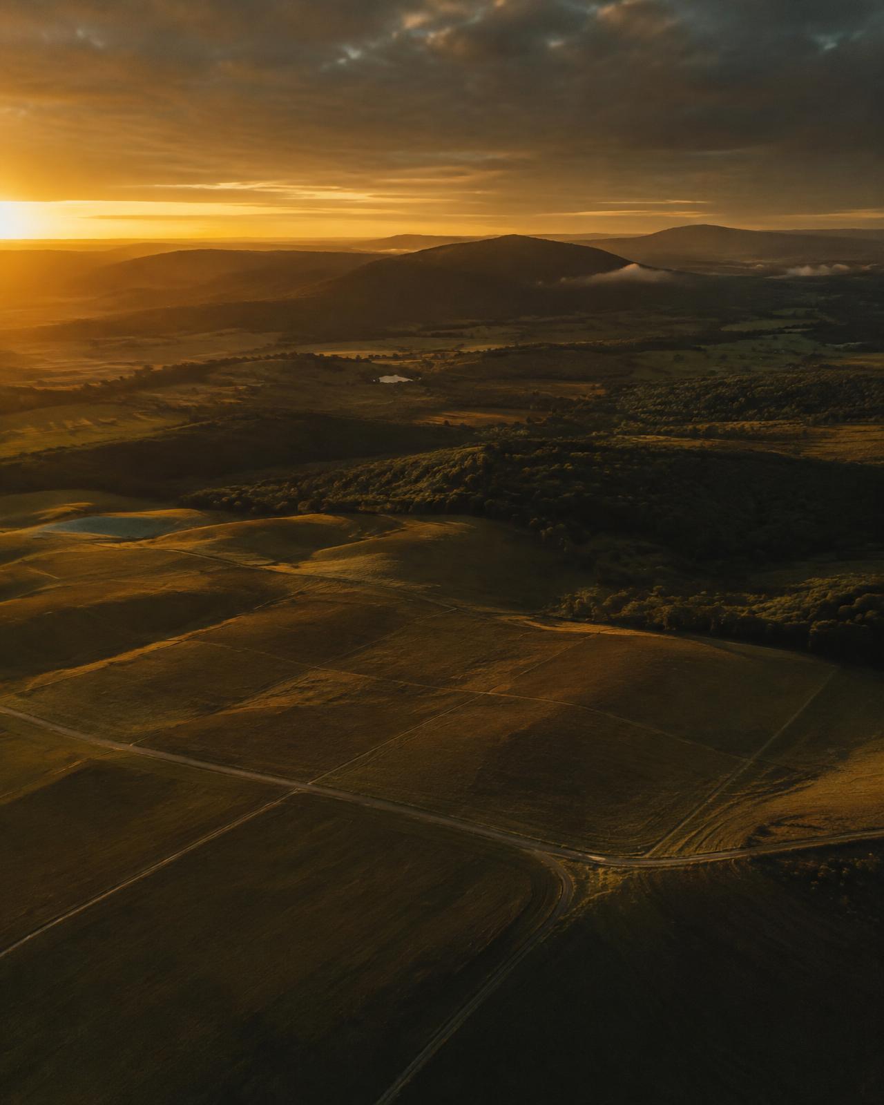 Representative aerial image of open land parcels at sunset